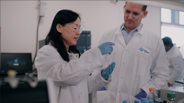 Woman and man working in Pfizer laboratory